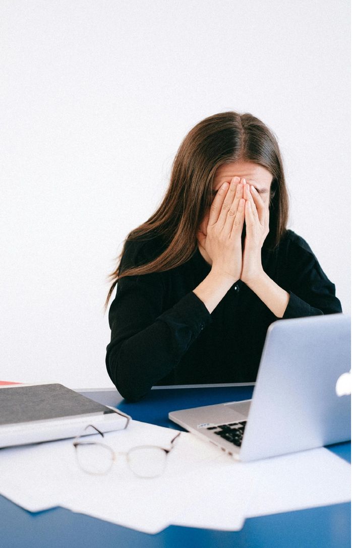 Woman feeling isolated at work, being pushed out of a job